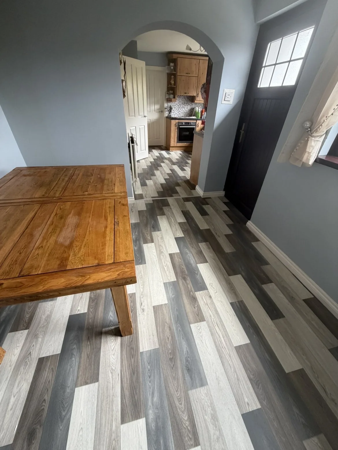Grey wood-effect vinyl running through a hallway