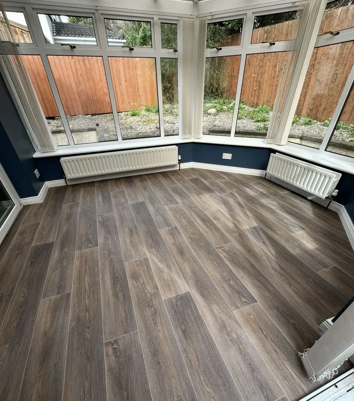 Wood-effect vinyl fitted in a bay-window conservatory